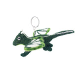 A needle felted flying dragon keychain, handcrafted and unique, is displayed against a stark white backdrop. This whimsical green dragon features a rounded body, pointed tail, small stubby legs, and dual-toned green and white wings. It has small white horns and a metal keychain with a clasp attached to its top.