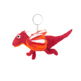 A whimsical red wool felt flying dragon keychain is playfully displayed against a bright white backdrop. The handcrafted felt dragon features a vibrant red body, a long tail, and four short legs. Its wings showcase layered white, orange, and red, complemented by white horns and a metal clasp attached to its head.