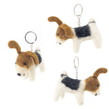 Three handmade Jack Russell felt keychains are suspended against a stark white background, creating a cheerful, floating display. Each charming keychain features a metal clasp and a round, felted Jack Russell dog with perky ears, white fur, and distinctive brown and black markings, highlighting their handcrafted details.