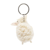 A handmade wool felt sheep keychain is displayed against a stark white backdrop. This cream-colored sheep features a fluffy, rounded body with tiny legs, a slender snout, and small ears, attached to a metal keychain with a clasp.