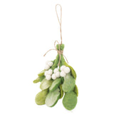 A Felt Mistletoe Sprig ornament is suspended by a jute string against a stark white background. This handcrafted felt ornament features several tie-dye felt leaves in varying shades of green, complemented by clusters of white felt berries. A rustic jute string is tied in a bow near the top, adding a charming detail to this unique Christmas ornament.