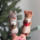 Handmade felt squirrel finger puppets holding acorn and nut, eco-friendly wool toys for kids, storytelling, or woodland pretend play.