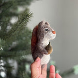 Handmade felt squirrel finger puppets holding acorn and nut, eco-friendly wool toys for kids, storytelling, or woodland pretend play.