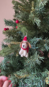 Handmade Jack Russell Dog Christmas ornament, made by Ganapati Crafts with organic wool and eco-friendly dyes, hanging on a Christmas tree.