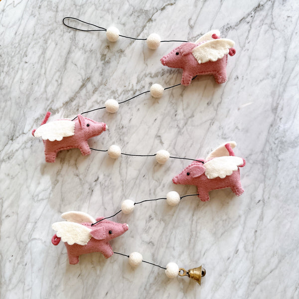 Flying piggy garland for kid's room designed by Ganapati Crafts Co. in Florida