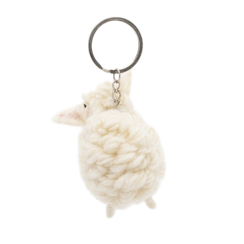 A handmade wool felt sheep keychain is displayed against a stark white backdrop. This cream-colored sheep features a fluffy, rounded body with tiny legs, a slender snout, and small ears, attached to a metal keychain with a clasp.