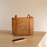 The Bali Rattan Woven Tote Bag handmade by Ganapati Crafts Co. in Bali where all the Rattan Bags are made is sitting on a table