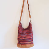 Red Woven sling bag with a zipper. Handmade in Nepal.