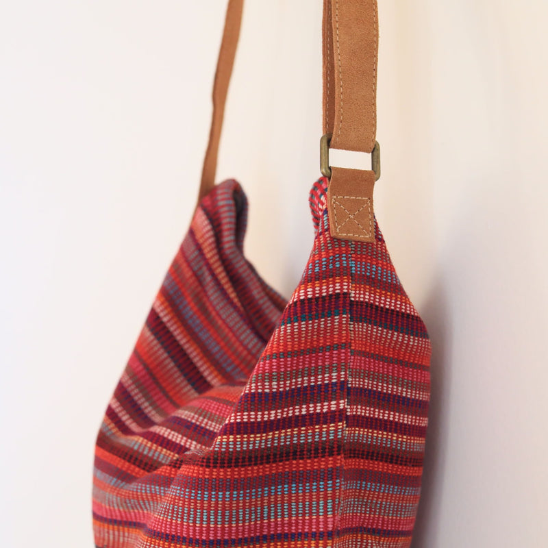 Red Woven sling bag with a zipper. Handmade in Nepal.
